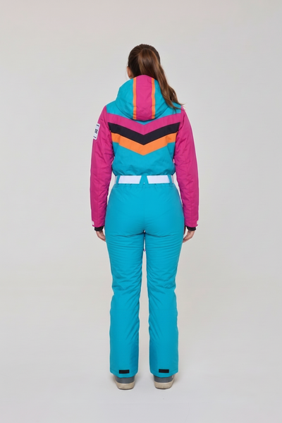woman wearing a green ski suit with a pink and orange stripes
